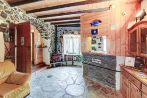 a kitchen with a couch and a window at New Arcobaleno Ossegna in Maissana