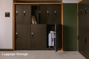 a room with wooden lockers with auggageuggagegraigunigunigunigunigun at LIVN Millennium Park Downtown Chicago Superior 1BR in Chicago +6 photos
