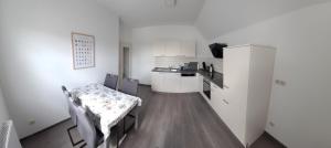 a room with a table and a kitchen with a table and chairs at Ferienwohnung Bischof in Echzell