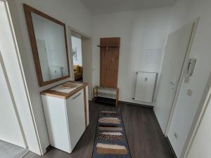a small bathroom with a mirror and a sink at Ferienwohnung Bischof in Echzell