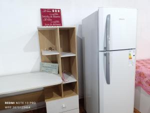 a kitchen with a refrigerator and some shelves at Casa Perla zamba in Cerrillos