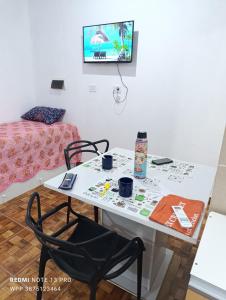 a room with a table and a chair and a bed at Casa Perla zamba in Cerrillos +5 photos