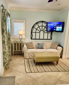 a living room with a couch and a flat screen tv at Coastal Dunes Escape in Santa Rosa Beach