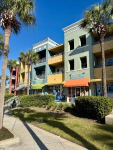 a building with palm trees in front of it at Coastal Dunes Escape in Santa Rosa Beach