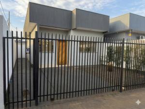 a black fence in front of a house at 3 Frontiers Landmark House in Foz do Iguaçu