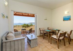 a living room with a couch and a table at Seaside Aqua Bliss & Serenity with Private Pool in Kranidi