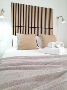 a bedroom with a large bed with white sheets and pillows at Easy4Stay in Portimão