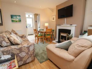 a living room with a couch and a fireplace at Hill View in Bala