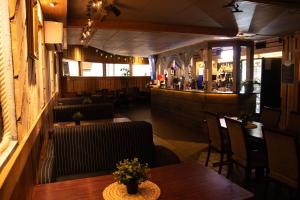 a restaurant with tables and chairs and a bar at Hotelli Kantakievari in Ruovesi +6 photos