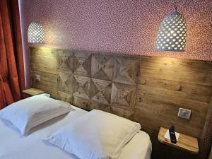 a bedroom with a bed with a wooden wall at Best Western Citadelle in Besançon