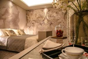 a bedroom with a bed and a table with a tray of fruit at Hotel Villa Pascucci in Durrës