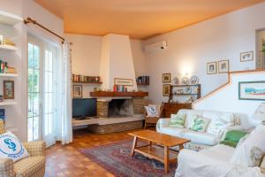 a living room with a couch and a fireplace at Villa Panorama in Bardolino