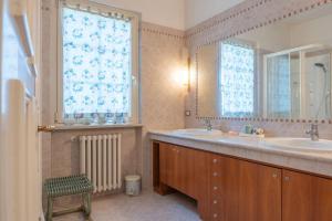 a bathroom with two sinks and a window at Villa Panorama in Bardolino +28 photos