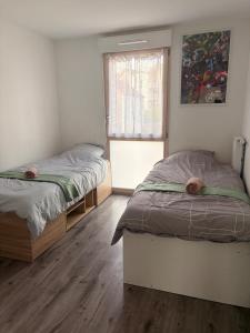 a bedroom with two beds and a window at DAKEY home - Disneyland Paris, Village Nature in Magny-le-Hongre