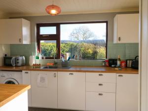 a kitchen with a sink and a window at Thadg and Hannahs in Milltown