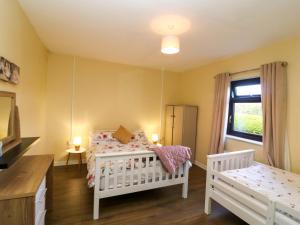 a childs bedroom with a crib and a window at Thadg and Hannahs in Milltown