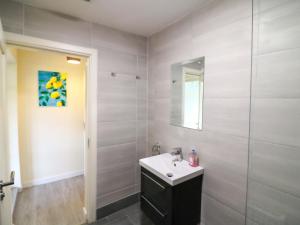 a bathroom with a sink and a shower with a mirror at Thadg and Hannahs in Milltown +52 photos