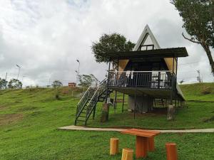 a tree house on a hill with a staircase at Mccp glamping and resort in Cavinti