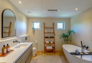 a bathroom with a large tub and a sink at Villa Mansour in Abu Dhabi