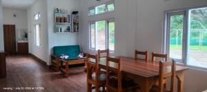 a dining room with a wooden table and chairs at Lanying Riverview Homestay in Dirang Dzong