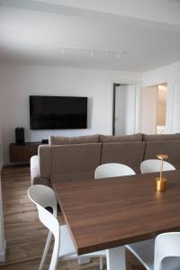 a living room with a couch and a table and chairs at Villa Serena - Luminor Apartment in Tirrenia