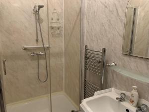 a bathroom with a shower and a sink at Coconut Cove in Blackpool