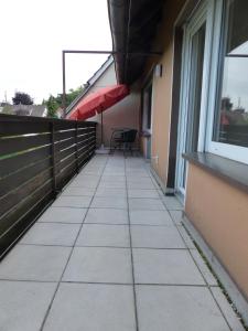 a balcony of a building with a table and chairs at Ferienwohnung Asenberg in Bad Salzuflen +7 photos