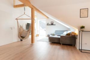 a living room with a couch and a hammock at SeeZeit Einruhr in Simmerath