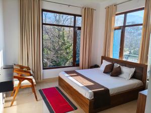 a bedroom with a bed and a large window at AeroVale Lodge I Mountain View Stay Near Landing Site Bir Billing in Bīr