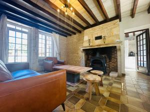 a living room with a couch and a fireplace at La Floraison in Molesmes