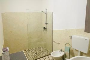 a bathroom with a shower and a toilet and a sink at Vicino Aeroporto - Orange Marina Room in Olbia