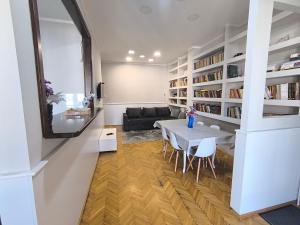 a living room with a table and a couch at Downtown apartment in walk zone with 3 bedrooms and garage in Novi Sad