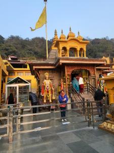 a woman standing in front of a temple at Commander's Home in Kangra