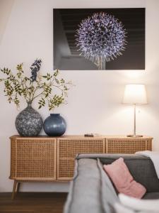 a living room with two vases and a couch at Strandhotel Domburg in Domburg +158 photos