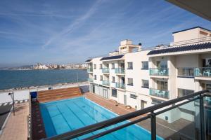 a swimming pool on the balcony of a building at Hotel Port Sitges in Sitges