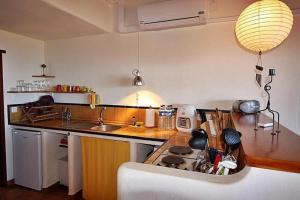 a kitchen with a sink and a stove top oven at Casa Estrella, Ferienhaus in Las Manchas in Las Manchas