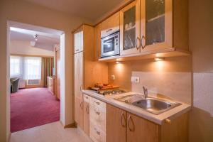 a kitchen with a sink and a microwave at Hotel Enzian in Pertisau +62 photos