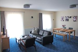 a living room with a couch and a table at Am Wiesenblick 2 Pers in Röbel