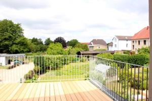 a balcony with a fence with a view of a yard at Am Wiesenblick 2 Pers in Röbel +16 photos