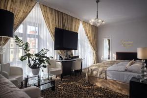 a hotel room with a bed and a desk at Hotel Grand in Český Krumlov