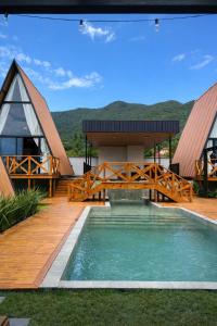 a view of a house with a bridge over a pool at Cabana Escandinávia Praia de Fora in Palhoça