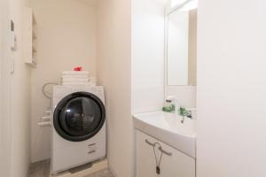 a washing machine in a bathroom next to a sink at Kag R大濠1 in Fukuoka