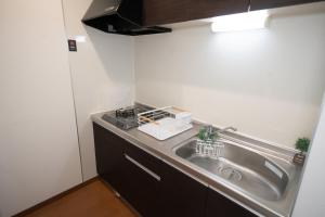 a kitchen with a sink and a counter at Kag R大濠1 in Fukuoka