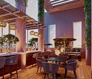 a restaurant with tables and chairs and a bar at Trizen OceanView in Colombo