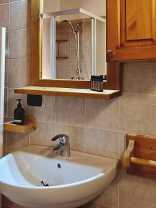 a white sink in a bathroom with a mirror at Residence Les Myosotis in Champoluc +130 photos