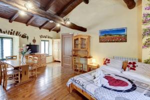 a bedroom with a bed and a table and a desk at New Arcobaleno Ossegna in Maissana +66 photos