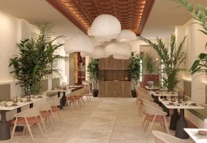 a restaurant with tables and chairs and potted plants at Fahana Triana 54 Adults Only in Las Palmas de Gran Canaria