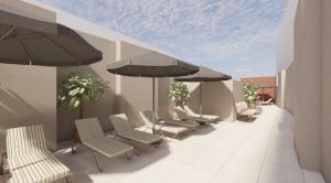 a group of chairs and umbrellas in a waiting room at Fahana Triana 54 Adults Only in Las Palmas de Gran Canaria