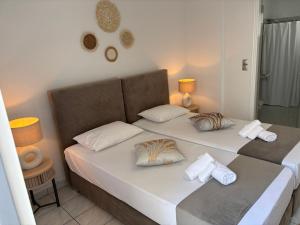 two twin beds in a room with two lamps at Chrysa House in Kamares +128 photos