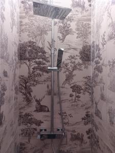 a bathroom with a wall mural of a forest at Casa di Aonio Paleario in Colle di Val d'Elsa +42 photos